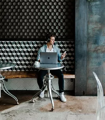 man staying connected through various devices like laptop and phone