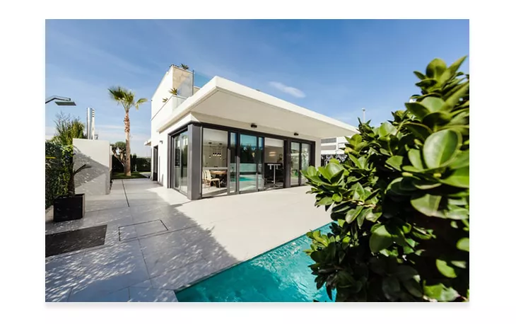 house with pool area surrounded by trees